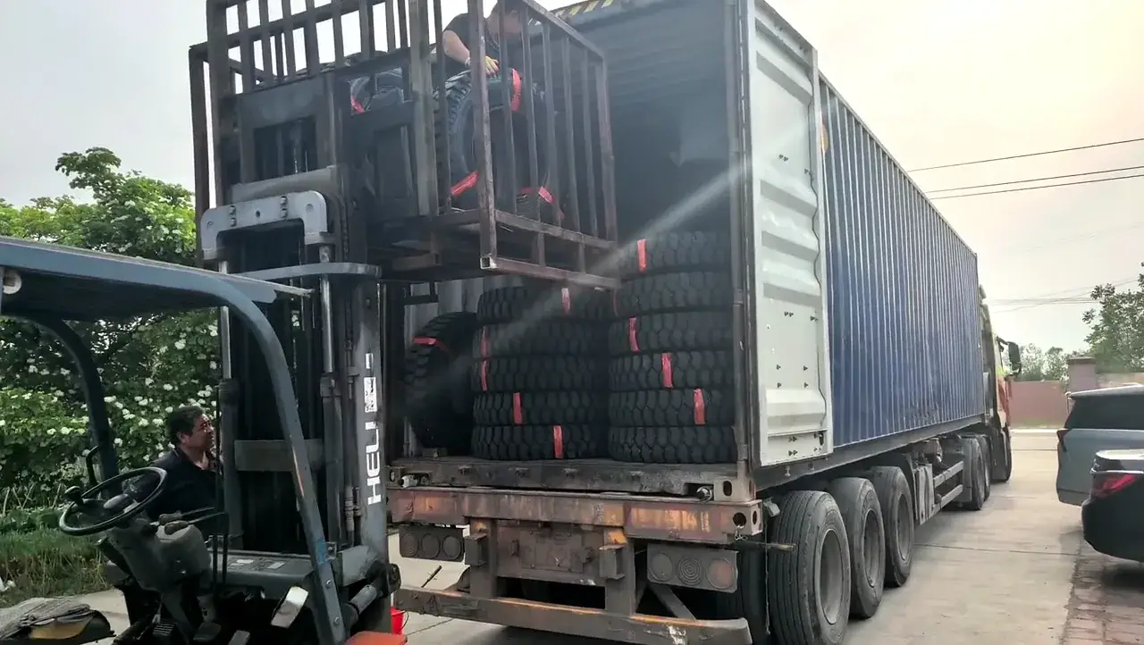 Forklift loading OTR tires into a container for shipment
